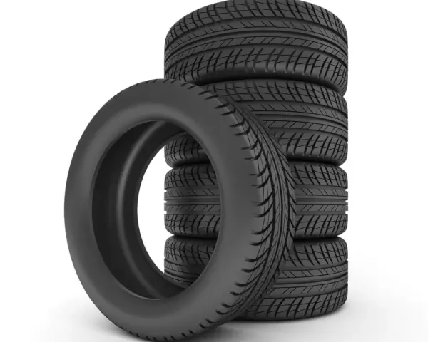 Pile de pneus de voiture noirs sur fond blanc.